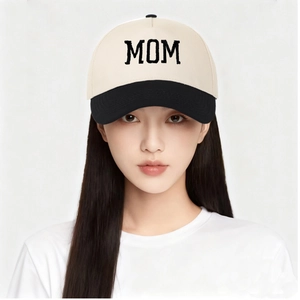 Close-up of MOM letter embroidery on two-tone canvas trucker hat with black brim