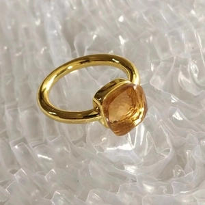 Close-up of golden stainless steel ring with a faceted yellow square cubic zirconia stone
