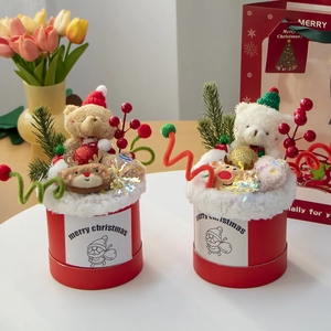 Detailed view of Christmas plush bear bouquets in red cylinders with reindeer and berries