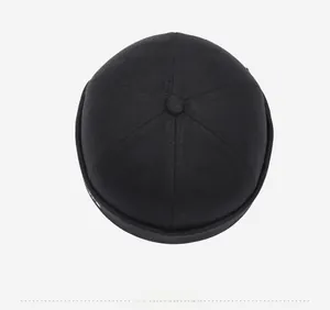 Top view of a black six-panel Miki hat showing cotton twill texture and top button