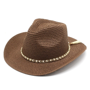 Detailed texture of dark brown straw hat with elegant pearl and gold chain strap