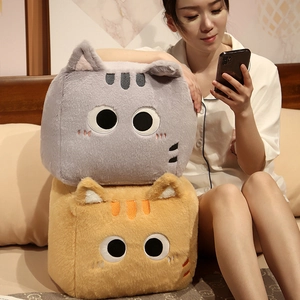 Detailed close-up of plush square cat pillows featuring delicate embroidery and soft fabric
