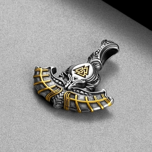 Macro detail of Viking Valknut pendant with silver finish and golden decorative edges