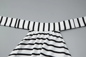 Close-up of black and white striped rib-knit texture and precise sewing craftsmanship