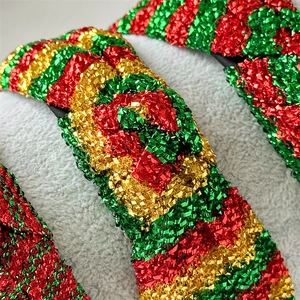 Detailed view of red green and gold glitter striped knotted headbands for Christmas