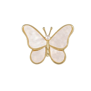 Elegant butterfly brooch with golden metal frame, pearlescent wings and central white pearl