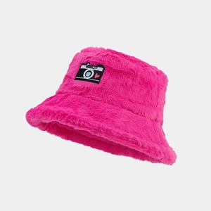 Close-up of bright rose pink faux fur bucket hat featuring a camera shaped heart embroidery patch