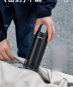 Close-up of black insulated water bottle with leak-proof seal shown in a backpack