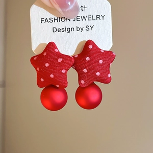 Detailed shot of fabric star earrings with red and white polka dots and matte round beads