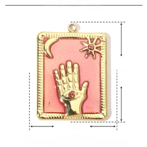 Detail of pink enamel star and moon pendant with dimensions 25mm by 18mm
