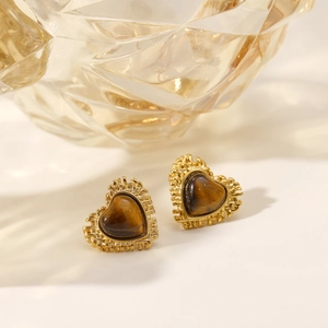 Vintage heart earrings with tiger eye stone and radial gold plating on white background