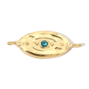 Detailed macro view of a gold oval jewelry connector with a sea blue round gemstone inlay
