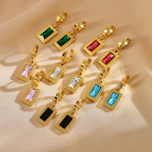 Detail view of gold rectangle hoop earrings with multi-color cubic zirconia on pink silk