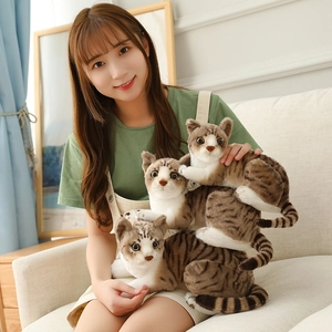 Realistic tabby cat plush toys held by a model on a sofa for home decoration