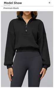 Detail of black half-zip sweatshirt featuring high collar and ribbed cuffs for sports