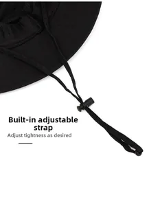 Detail of adjustable drawstring and toggle on a black outdoor sun hat for secure fit