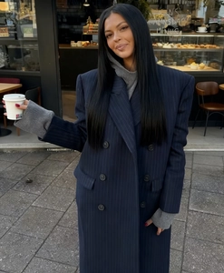 Detail of navy blue pinstripe oversized wool coat with double-breasted buttons