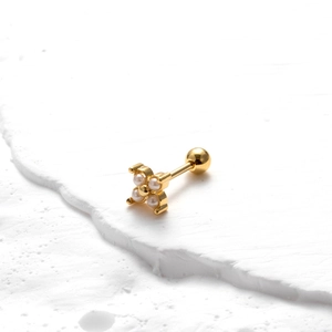 Detailed view of golden flower stud earring with pearls and screw back ball closure