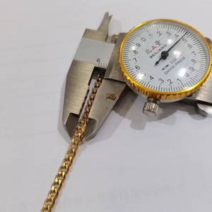 Detail shot measuring 3mm width of golden stainless steel cuban chain necklace