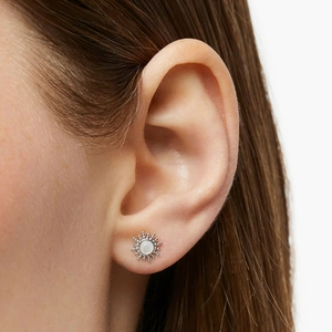 Close-up of S925 sterling silver sun-shaped stud earrings with opal on earlobe