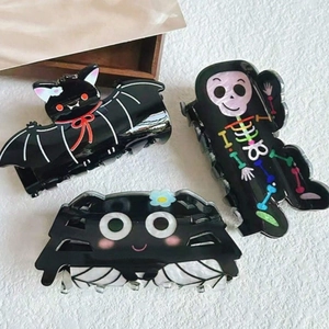 Halloween hair claws set with black spider, bat, and skull coffin designs for women
