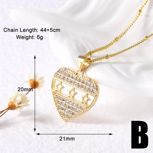 Macro detail of gold plated heart pendant necklace with stars and pave cubic zirconia