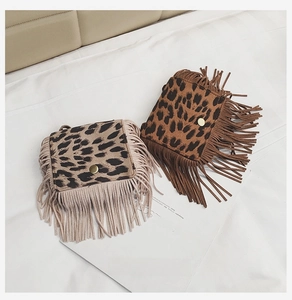 Detailed view of leopard print kids crossbody bags with fringes and gold magnetic buckles