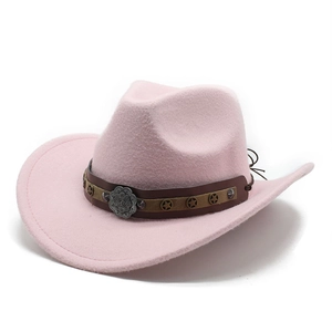 Detail view of pink felt cowboy hat featuring studded brown band and metal flower buckle
