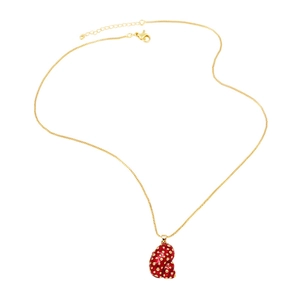 Golden necklace with red enamel shell pendant featuring gold polka dots on white background