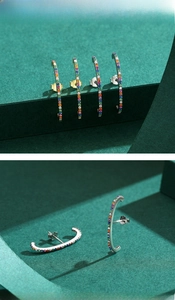 Macro shot of S925 sterling silver rainbow cubic zirconia earrings in gold and silver plating