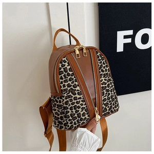 Detail of leopard print canvas and brown PU leather stitching on a mini backpack