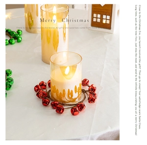 Christmas wreath with red and green bells used as a festive candle holder base decor