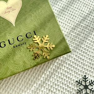 Detailed macro shot of golden snowflake cake topper on luxury gift box background
