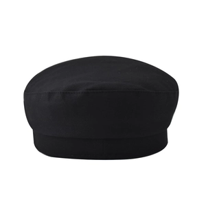Detailed top view of a minimalist black cotton newsboy cap with clean stitching detail