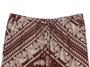 Detail of drawstring elastic waist and paisley print on coffee casual trousers