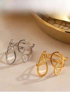Detailed view of intertwined crossover knot rings in polished gold and silver finishes