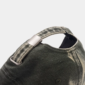 Detailed macro view of the vintage washed cotton baseball cap with adjustable metal buckle