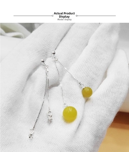 Detailed view of S925 sterling silver drop earrings with yellow beads and fine chains