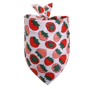 Close-up of a white cotton dog bandana featuring vibrant red and pink strawberry patterns