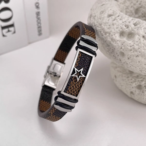 Detail of a brown checkered leather bracelet with stainless steel star charm