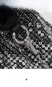 Detailed macro shot of silver rhinestones and metallic D-ring buckle on evening bag
