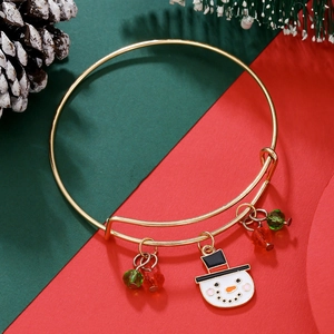 Detail of Christmas snowman pendant bracelet with red and green beads on holiday background