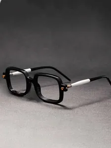 Detailed macro view of square black frame glasses with black and white spliced temples