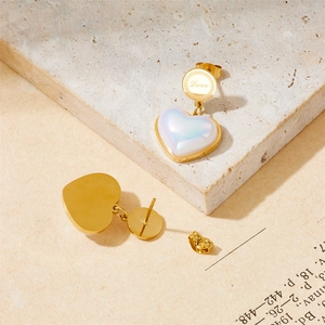 Elegant gold heart earrings with pearl luster inlay and Love engraving on beige stone