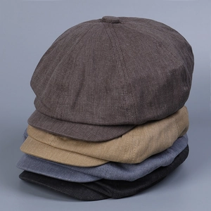 Vertical stack of retro newsboy caps in twill cotton fabric showing multiple colors