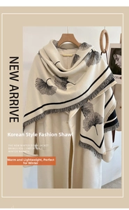 Detail of cream pashmina scarf with black ginkgo leaf prints and fringe trim