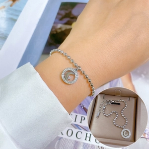 Detailed view of silver star and moon pendant bracelet with sleek metal bead chain