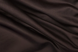 Close-up of dark chocolate knitted fabric showing fine texture and elegant drape