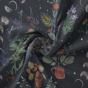 Macro detail of bohemian tapestry fabric featuring strawberry, moon, and floral prints