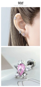 Macro detail of star-shaped cartilage stud earrings with sparkling drop-cut zircons
